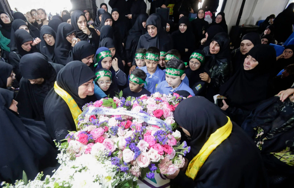 Relatives and others wailing around the body of a person killed in a pager explosion. Photo: AFP